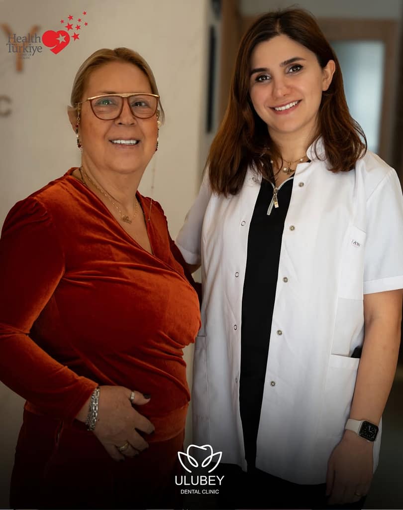 Mitra Vahedi smiling with Dr. Surur Ulubey after her full mouth reconstruction with zirconia crowns in Antalya